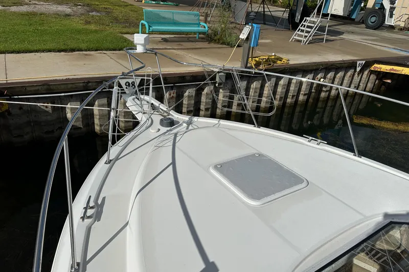Slide: The Image of 1997 Carver 325 Motor Yacht docked, showing bow and railing details. - 9