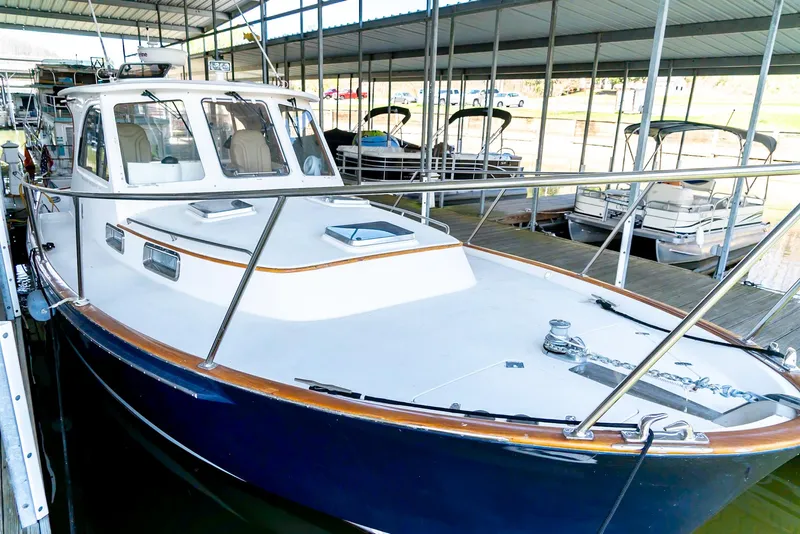 Slide: The Image of 2002 Legacy 34 Express boat docked in a marina. - 11