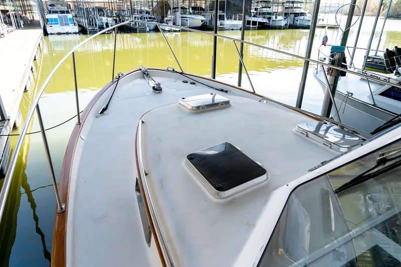 Slide: The Image of 2002 Legacy 34 Express boat docked at a marina. - 13