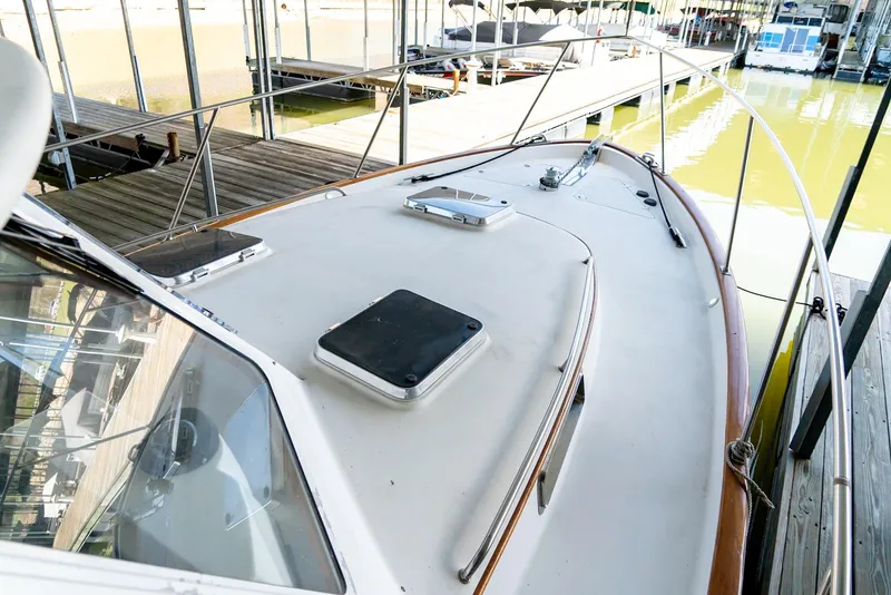 Slide: The Image of 2002 Legacy 34 Express boat docked at a marina. - 14