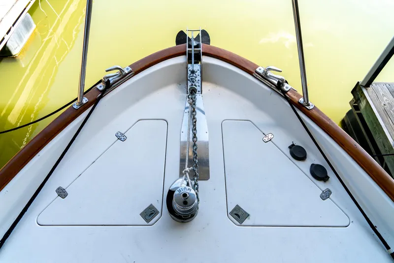 Slide: The Image of Bow of 2002 Legacy 34 Express boat with anchor and chain mechanism. - 15