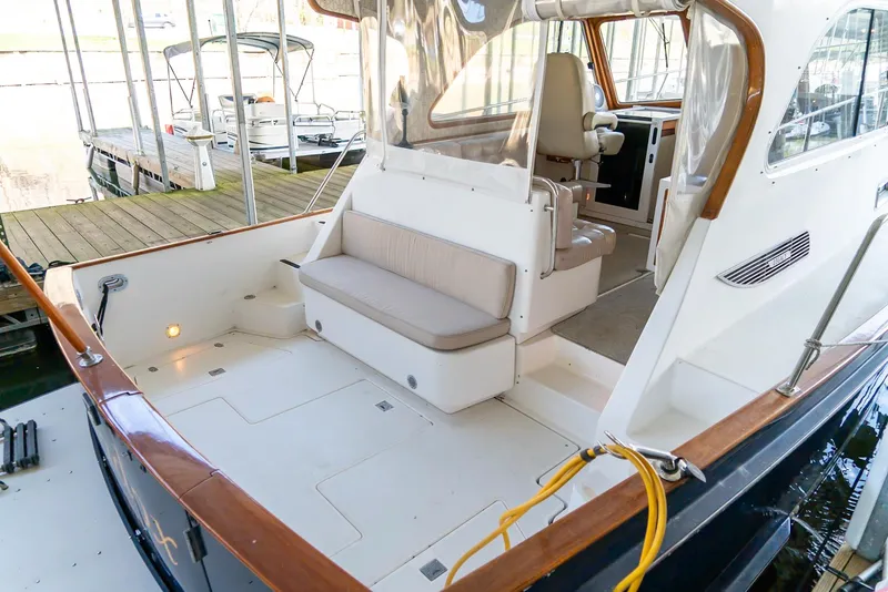 Slide: The Image of 2002 Legacy 34 Express boat with spacious cockpit and comfortable seating. - 20