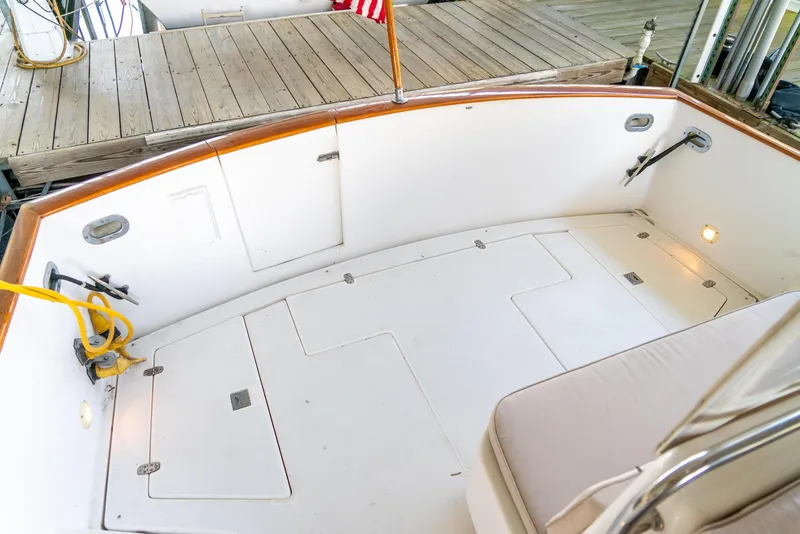 Slide: The Image of 2002 Legacy 34 Express boat deck with storage compartments and seating. - 22