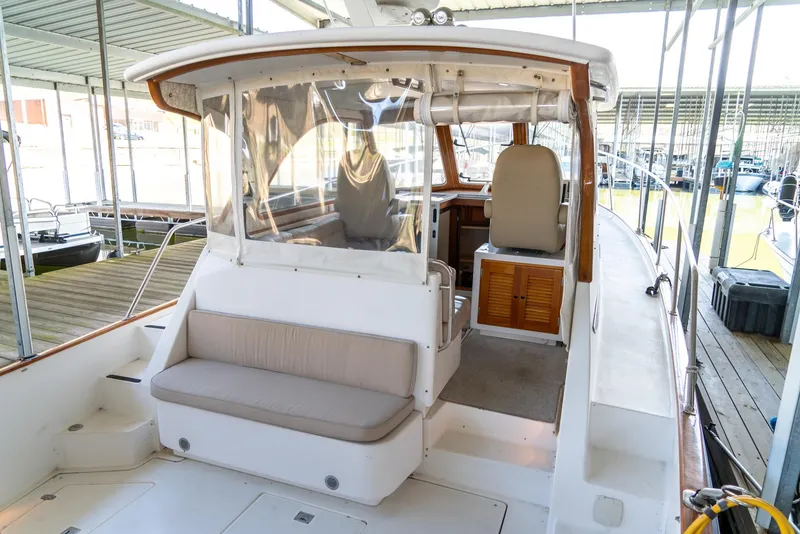Slide: The Image of 2002 Legacy 34 Express boat interior with seating and helm station. - 23