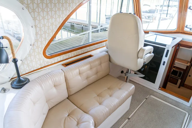 Slide: The Image of Interior of 2002 Legacy 34 Express yacht with beige leather seating and helm station. - 25