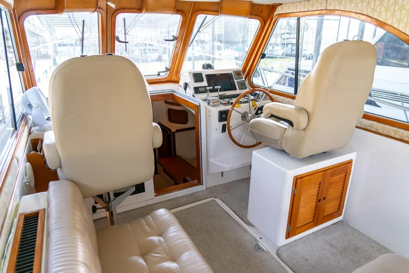 Slide: The Image of Interior of 2002 Legacy 34 Express boat with helm station and seating. - 26