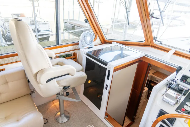Slide: The Image of 2002 Legacy 34 Express boat helm with captain's chair and navigation equipment. - 29