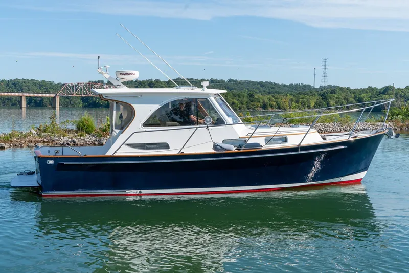 Slide: The Image of 2002 Legacy 34 Express boat on calm water with scenic background. - 4