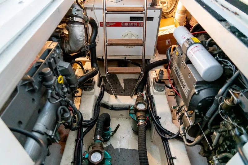 Slide: The Image of Engine room of a 2002 Legacy 34 Express boat with visible machinery and equipment. - 44