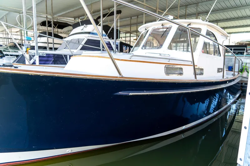 Slide: The Image of 2002 Legacy 34 Express boat docked in a marina. - 8