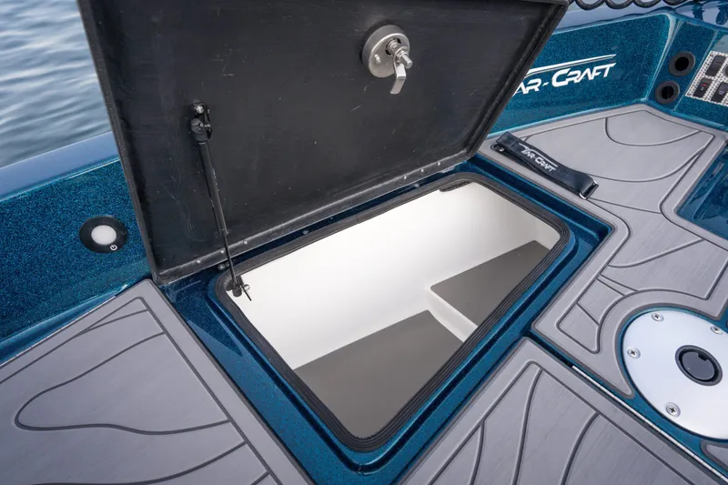 Slide: The Image of 2025 Yar-Craft 210 TFX SP boat storage compartment open on deck. - 12