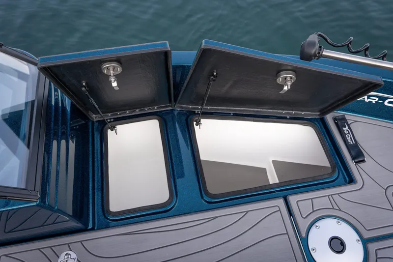 Slide: The Image of 2025 Yar-Craft 210 TFX SP boat storage compartments open on deck. - 14