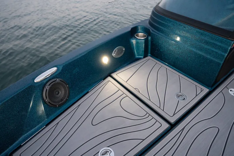 Slide: The Image of 2025 Yar-Craft 210 TFX SP boat deck with storage compartments and speaker, illuminated by LED light. - 15