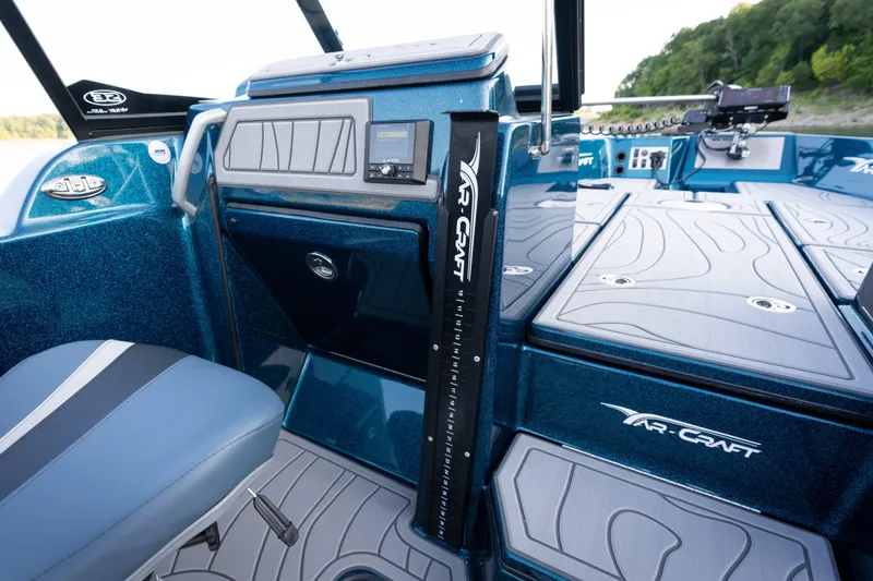 Slide: The Image of 2025 Yar-Craft 210 TFX SP boat interior with blue seating and advanced dashboard features. - 16