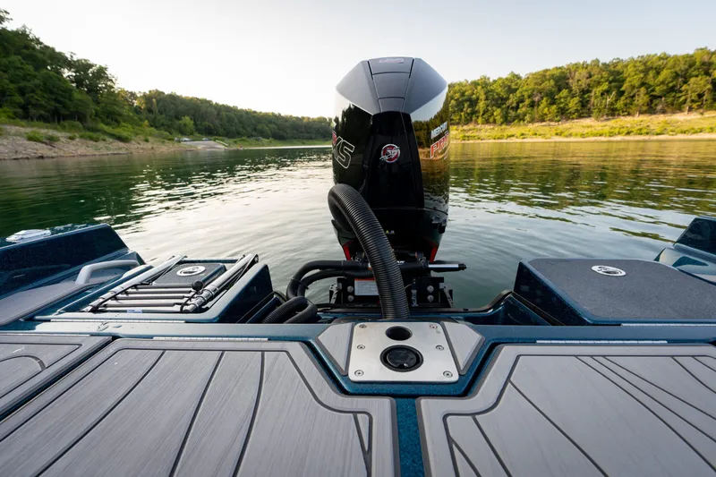 Slide: The Image of 2025 Yar-Craft 210 TFX SP boat on a serene lake, showcasing its powerful engine. - 5
