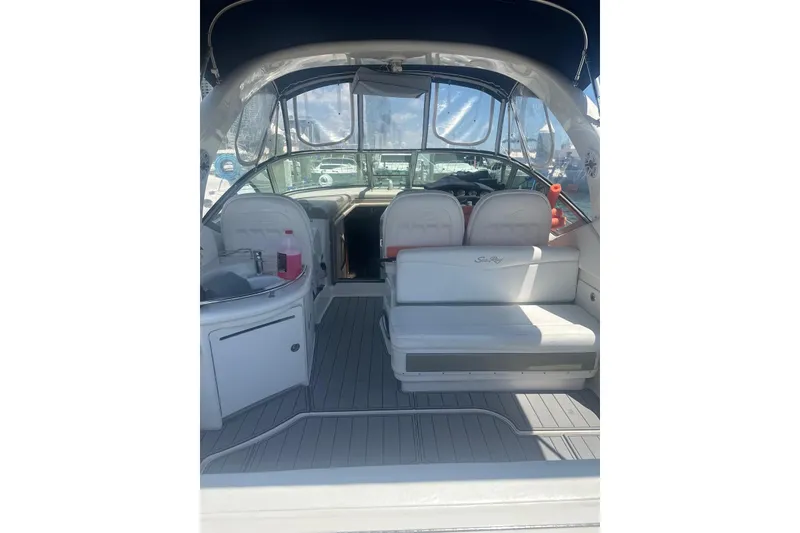 Slide: The Image of 2006 Sea Ray 340 Sundancer interior with seating and helm, featuring sleek design and comfort. - 14
