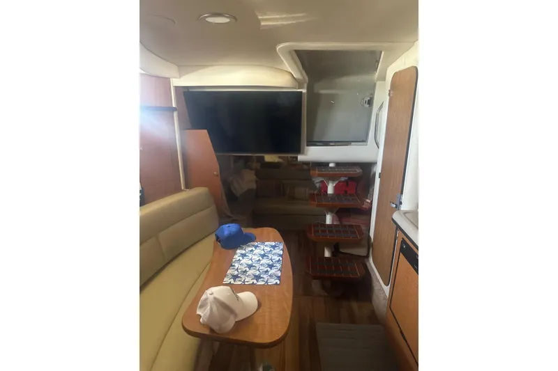 Slide: The Image of Interior of 2006 Sea Ray 340 Sundancer yacht with seating, table, and steps. - 19