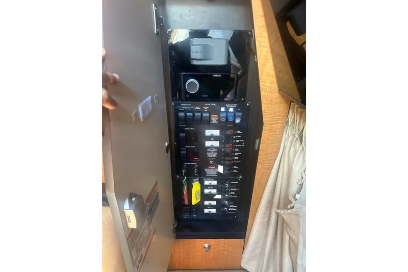 Slide: The Image of Electrical panel inside 2006 Sea Ray 340 Sundancer boat, featuring various switches and controls. - 22