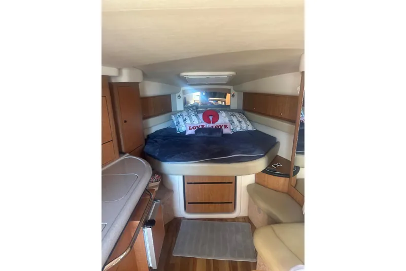 Slide: The Image of Interior of 2006 Sea Ray 340 Sundancer with cozy bed and wooden cabinetry. - 24