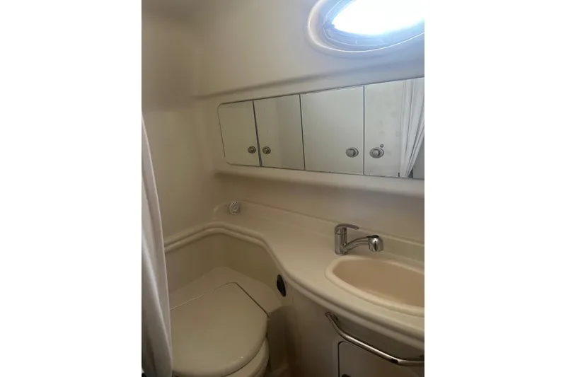Slide: The Image of 2006 Sea Ray 340 Sundancer bathroom with sink, mirror, and toilet. - 26