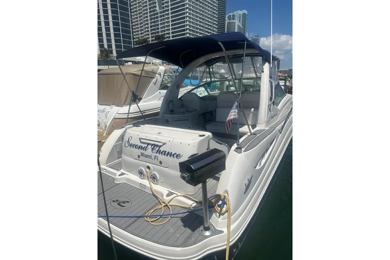 Slide: The Image of 2006 Sea Ray 340 Sundancer docked in Miami marina with city skyline. - 5