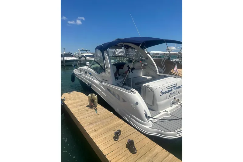Slide: The Image of 2006 Sea Ray 340 Sundancer docked under clear blue sky. - 6