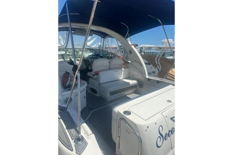 Slide: The Image of 2006 Sea Ray 340 Sundancer boat interior with seating and canopy, docked at marina. - 8