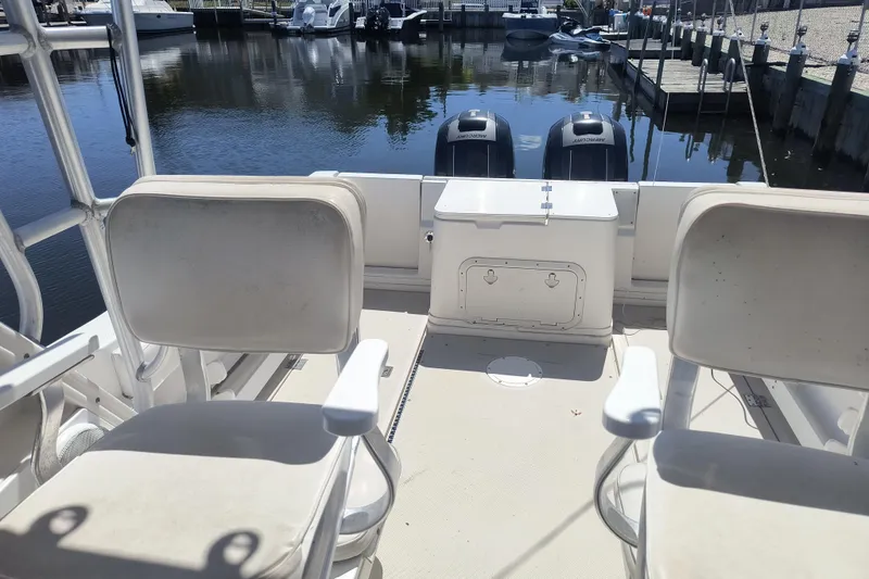 Slide: The Image of 1995 Robalo 2440 Walkaround boat interior with seating and dual outboard motors. - 6