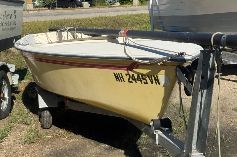 The Image of 1986 Hobie Cat Holder 14 sailboat on trailer, parked outdoors. - 1