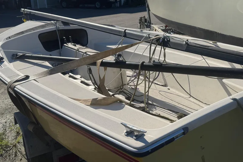 Slide: The Image of 1986 Hobie Cat Holder 14 sailboat with rigging, on a trailer, in a sunny outdoor setting. - 5