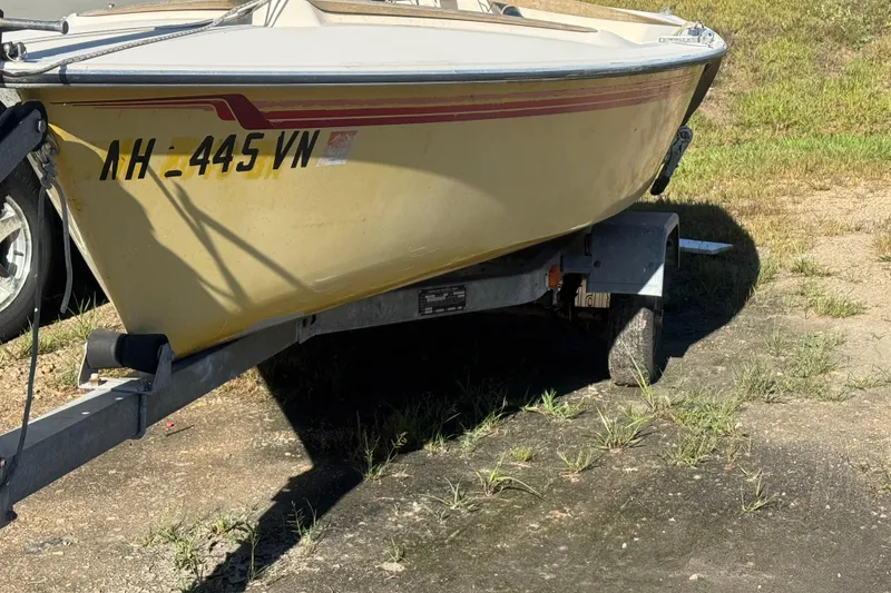 Slide: The Image of 1986 Hobie Cat Holder 14 sailboat on trailer, parked on grassy area. - 7
