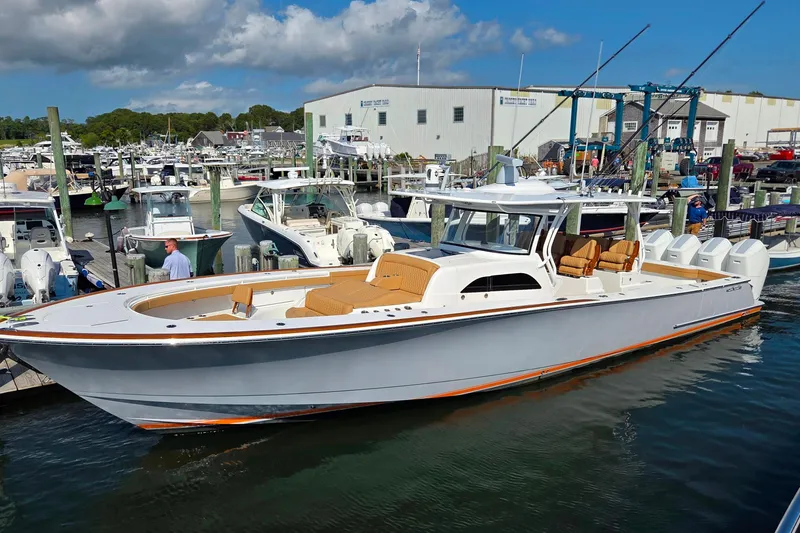 Slide: The Image of 2023 Valhalla Boatworks V-46 docked at a marina under a partly cloudy sky. - 14