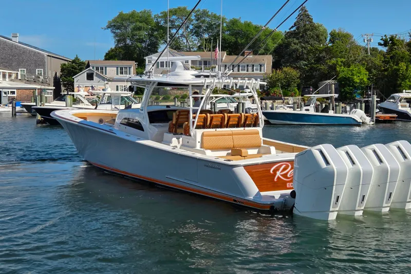 Slide: The Image of 2023 Valhalla Boatworks V-46 in marina, featuring sleek design and powerful engines. - 17