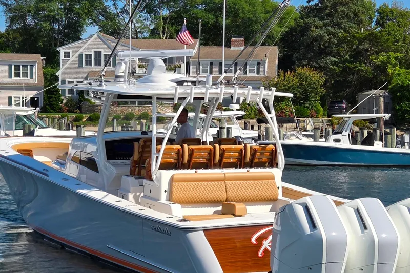 Slide: The Image of 2023 Valhalla Boatworks V-46 luxury boat docked near waterfront homes. - 18