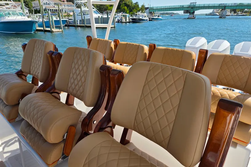 Slide: The Image of Luxurious seating on 2023 Valhalla Boatworks V-46, featuring diamond-stitched upholstery and wooden accents. - 31