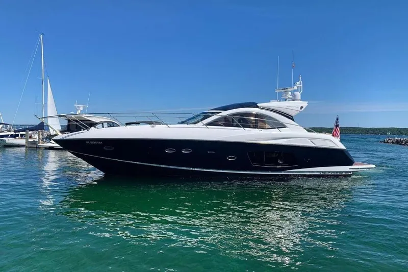 The Image of 2012 Sunseeker Portofino 48 yacht docked in a sunny marina. - 0