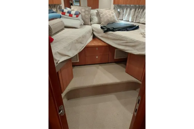 Slide: The Image of Interior cabin of 2012 Sunseeker Portofino 48 yacht with cozy bedding and wooden finish. - 12