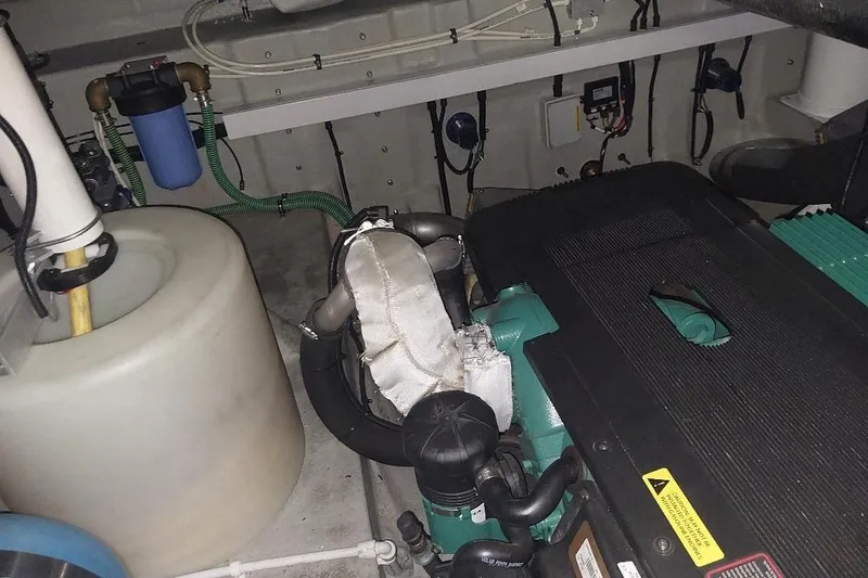 Slide: The Image of Engine room of a 2012 Sunseeker Portofino 48 yacht, showcasing mechanical components. - 14