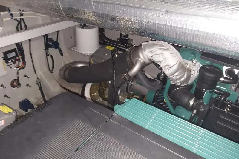 Slide: The Image of Engine room of 2012 Sunseeker Portofino 48 yacht, showcasing mechanical components. - 16