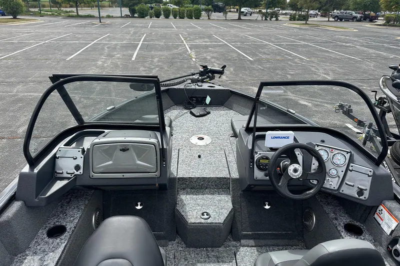 Slide: The Image of 2026 Tracker Pro Guide V-175 Combo boat interior with steering wheel and dashboard controls. - 2