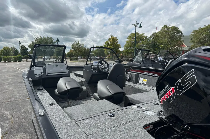 Slide: The Image of 2026 Tracker Pro Guide V-175 Combo boat with Mercury Pro XS engine in a parking lot. - 3