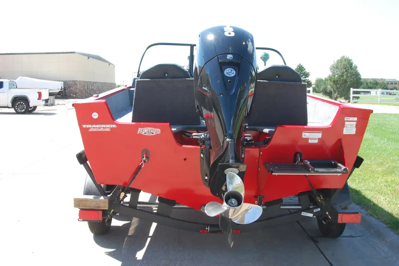 Slide: The Image of 2026 Tracker Pro Guide V-175 Combo boat, red exterior, rear view with outboard motor. - 3