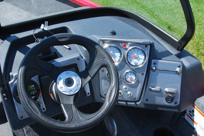 Slide: The Image of 2026 Tracker Pro Guide V-175 Combo boat dashboard with steering wheel and gauges. - 8