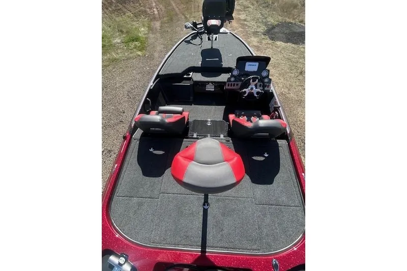 Slide: The Image of 2025 Nitro Z19 boat interior with red and gray seating, steering console, and carpeted deck. - 11