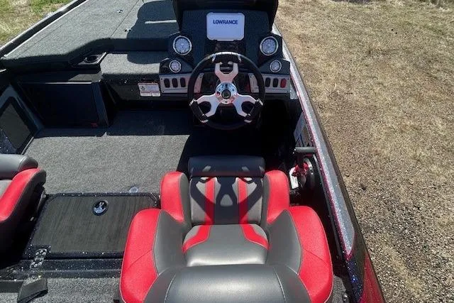 Slide: The Image of Interior of 2025 Nitro Z19 boat with red and gray seating and steering console. - 12
