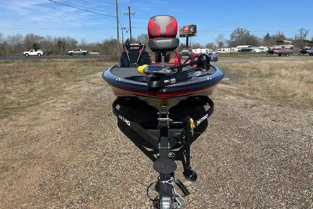 Slide: The Image of 2025 Nitro Z19 boat on trailer, parked on gravel, with clear blue sky background. - 19