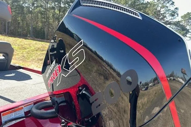 Slide: The Image of 2025 Nitro Z19 boat with Mercury Pro XS 200 engine, outdoors in a sunny setting. - 2