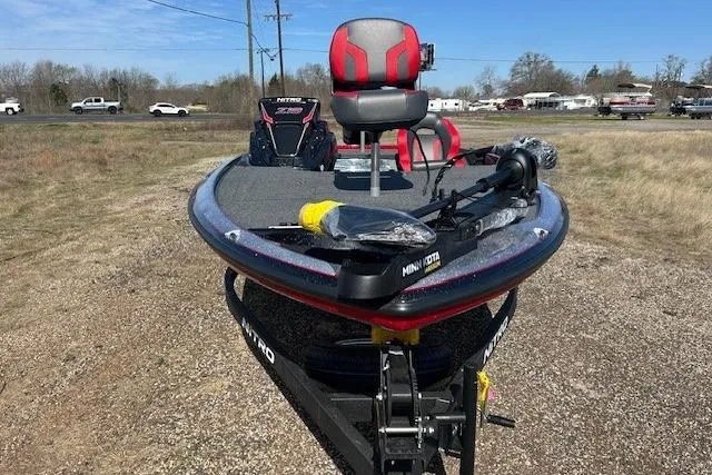 Slide: The Image of 2025 Nitro Z19 fishing boat with red seats and Minn Kota trolling motor. - 6