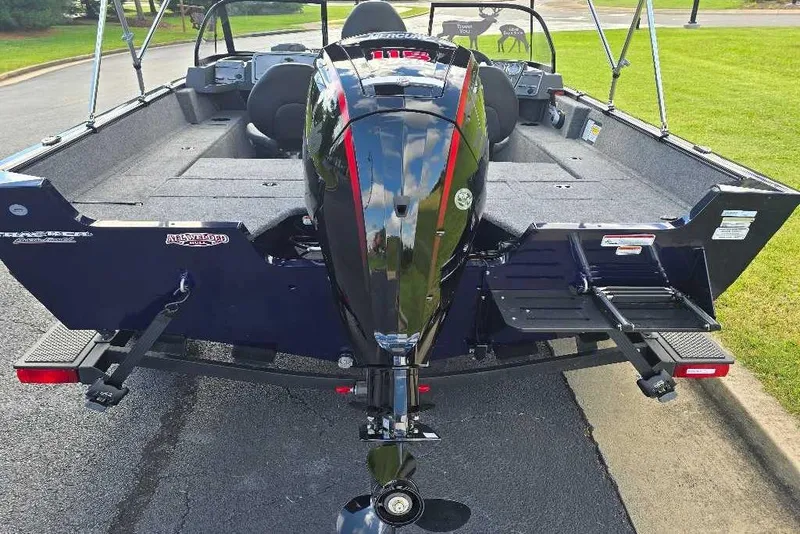 Slide: The Image of 2026 Tracker Pro Guide V-175 Combo boat on trailer, parked outdoors. - 2
