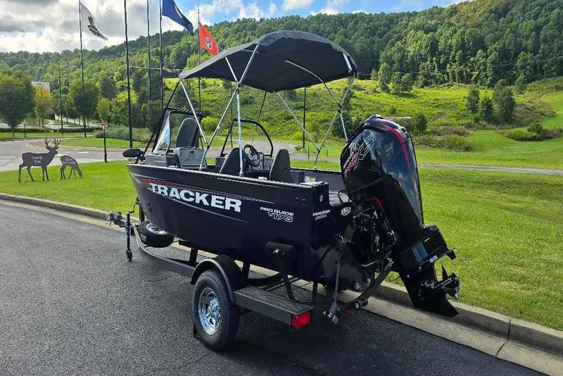 Slide: The Image of 2026 Tracker Pro Guide V-175 Combo boat, rear view with motor and seating. - 3
